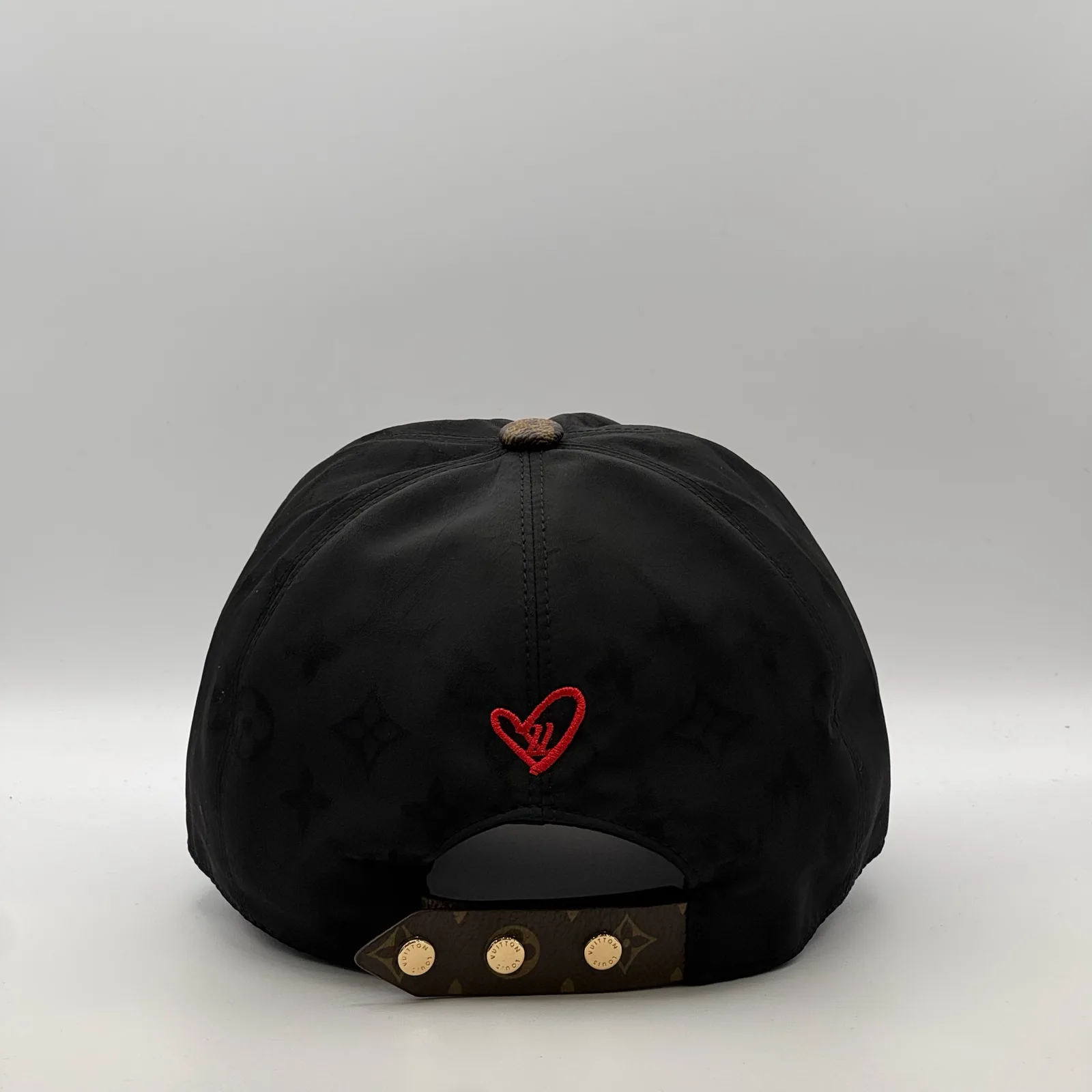 Black Signature cap, back view showing the red heart embroidery.