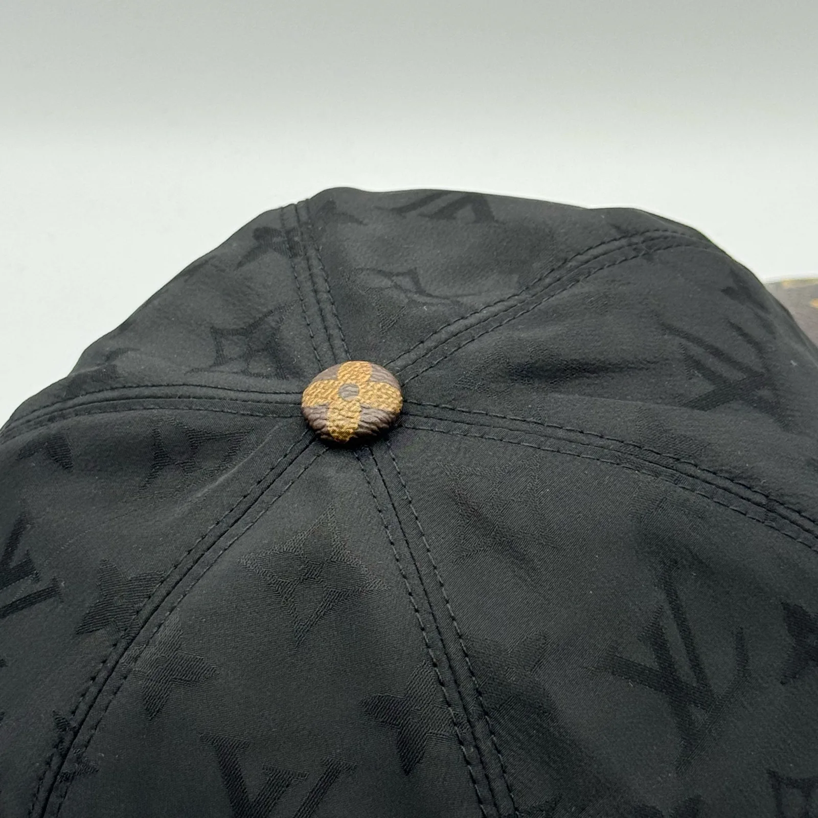 Black Signature cap, top-down view of the crown.
